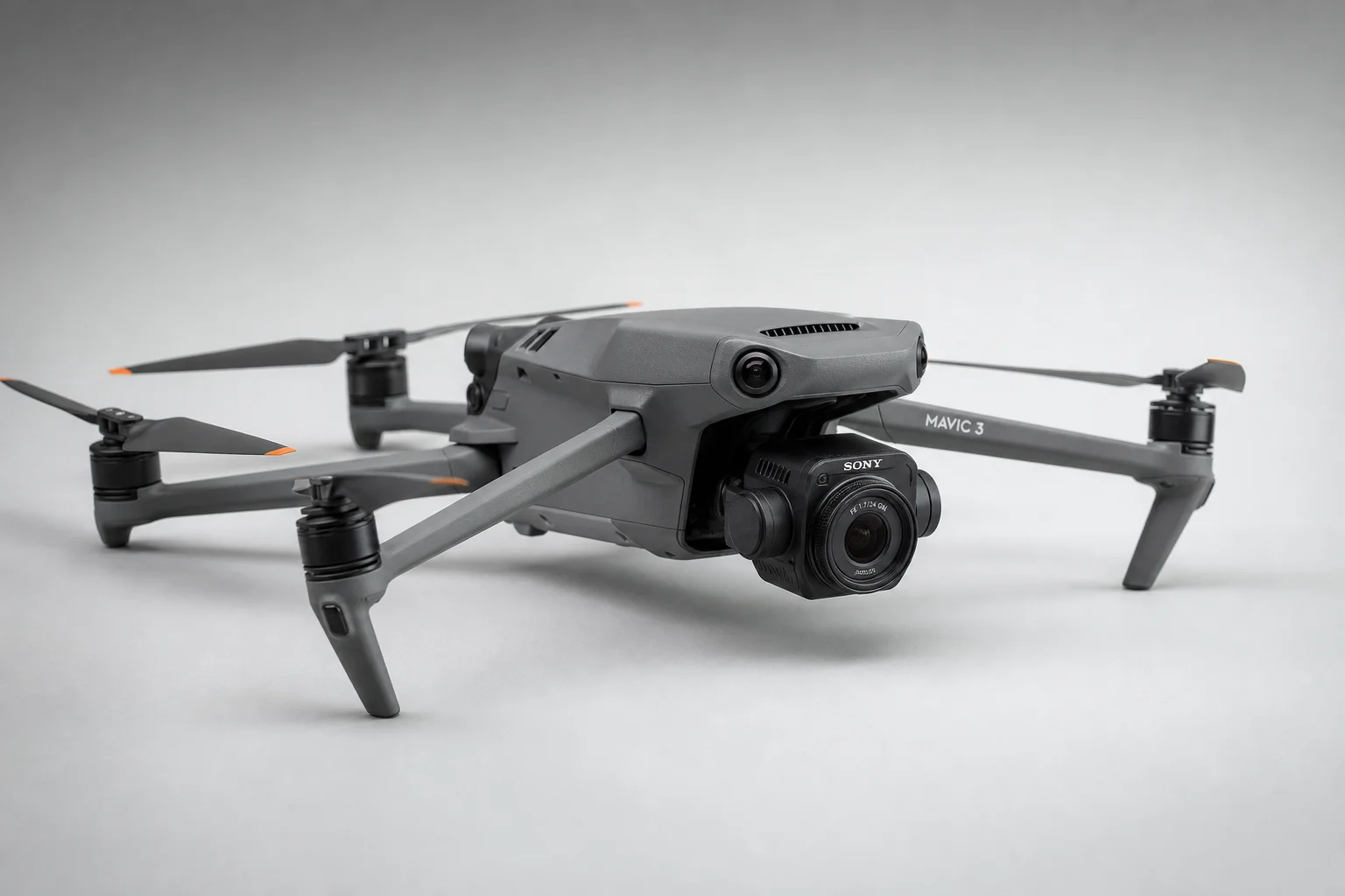 Five drones arranged on concrete surface showing different designs and sizes