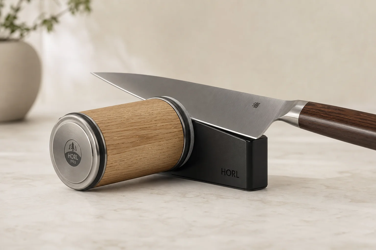 HORL rolling knife sharpener with magnetic angle support and kitchen knife on marble surface