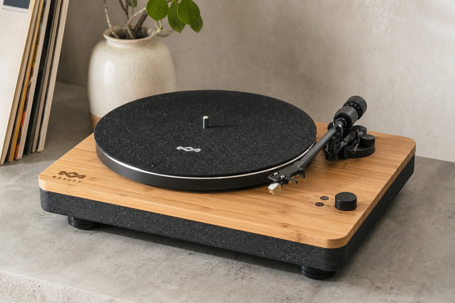 Five vinyl turntables arranged by price tier on concrete surface
