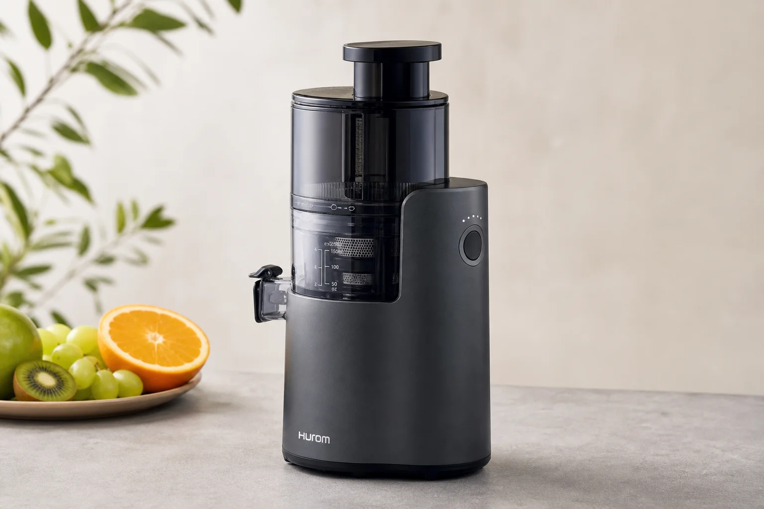 Four cold-press juicers arranged on concrete surface showing different sizes and designs