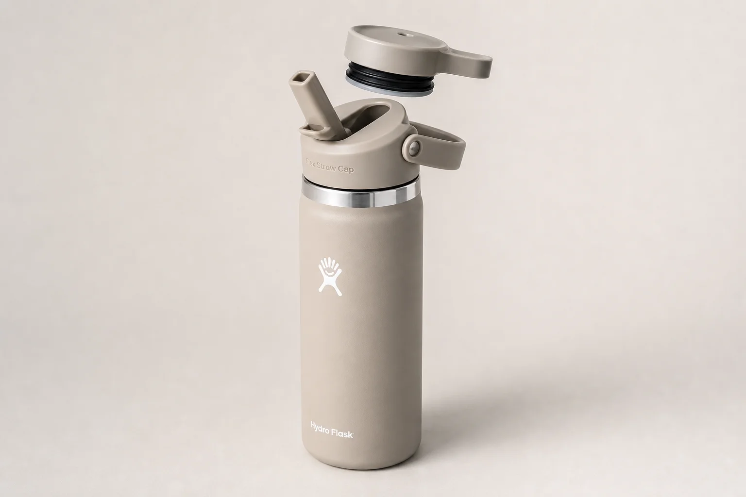 Six insulated water bottles from different brands arranged on concrete surface