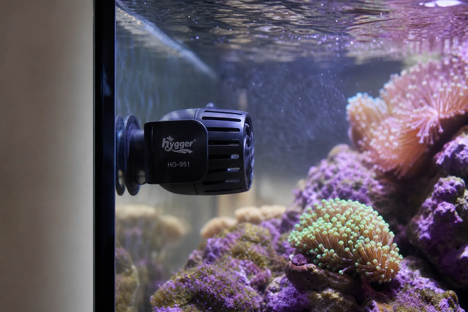 Wave maker mounted in aquarium with magnetic bracket and corals nearby