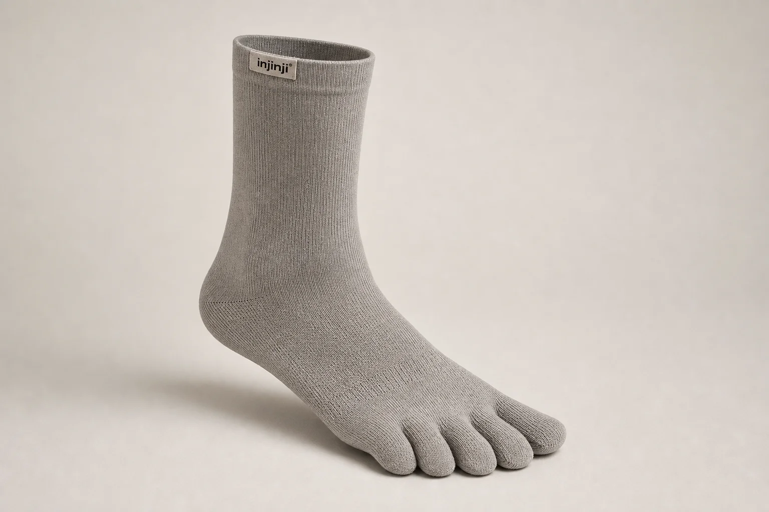 Collection of running socks in various colors and styles arranged on concrete surface