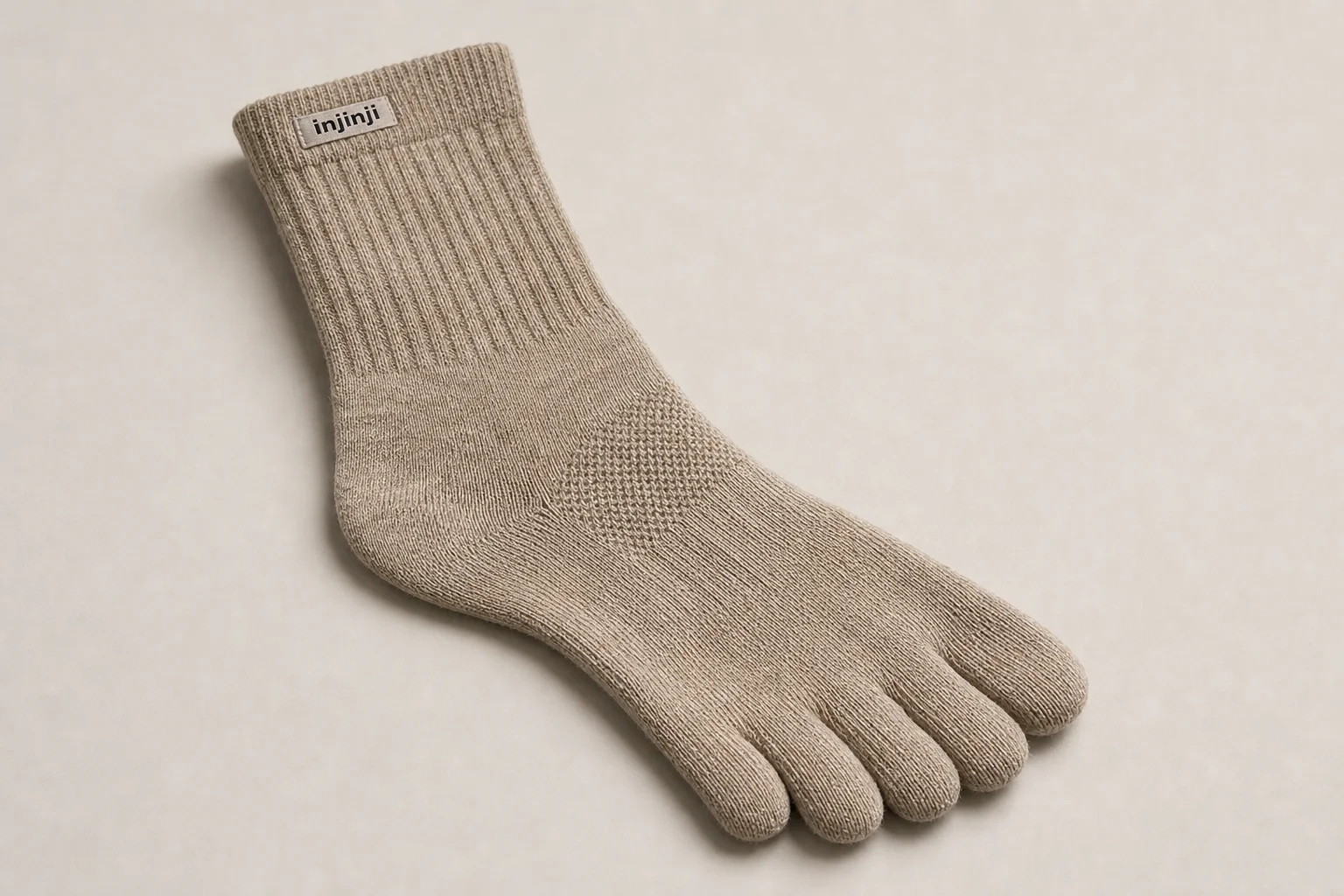 Collection of running socks in various colors and styles arranged on concrete surface