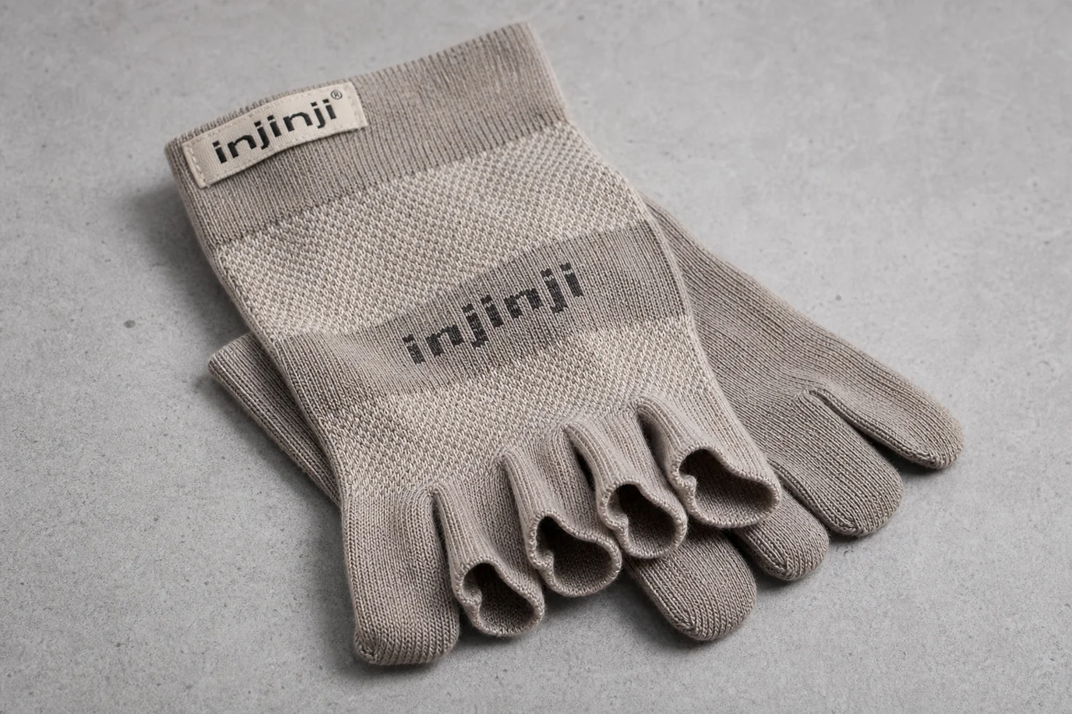 Collection of hiking socks in various styles and materials on neutral backdrop