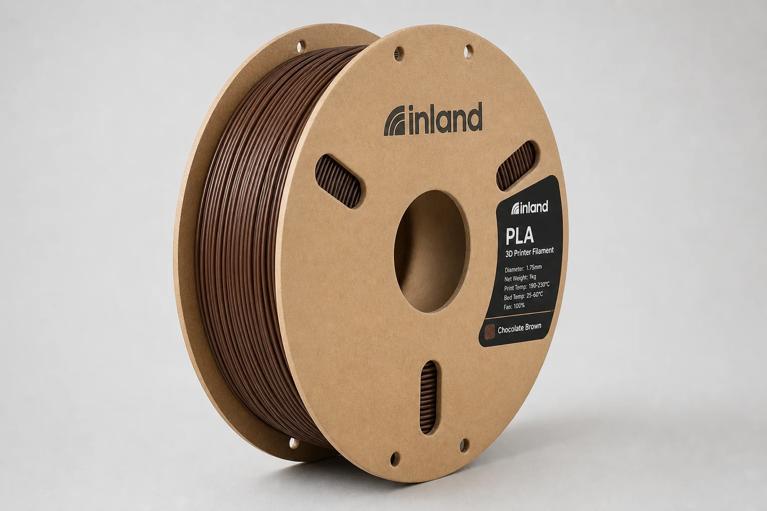Cinq bobines de filament PLA colorées disposées sur une surface en béton