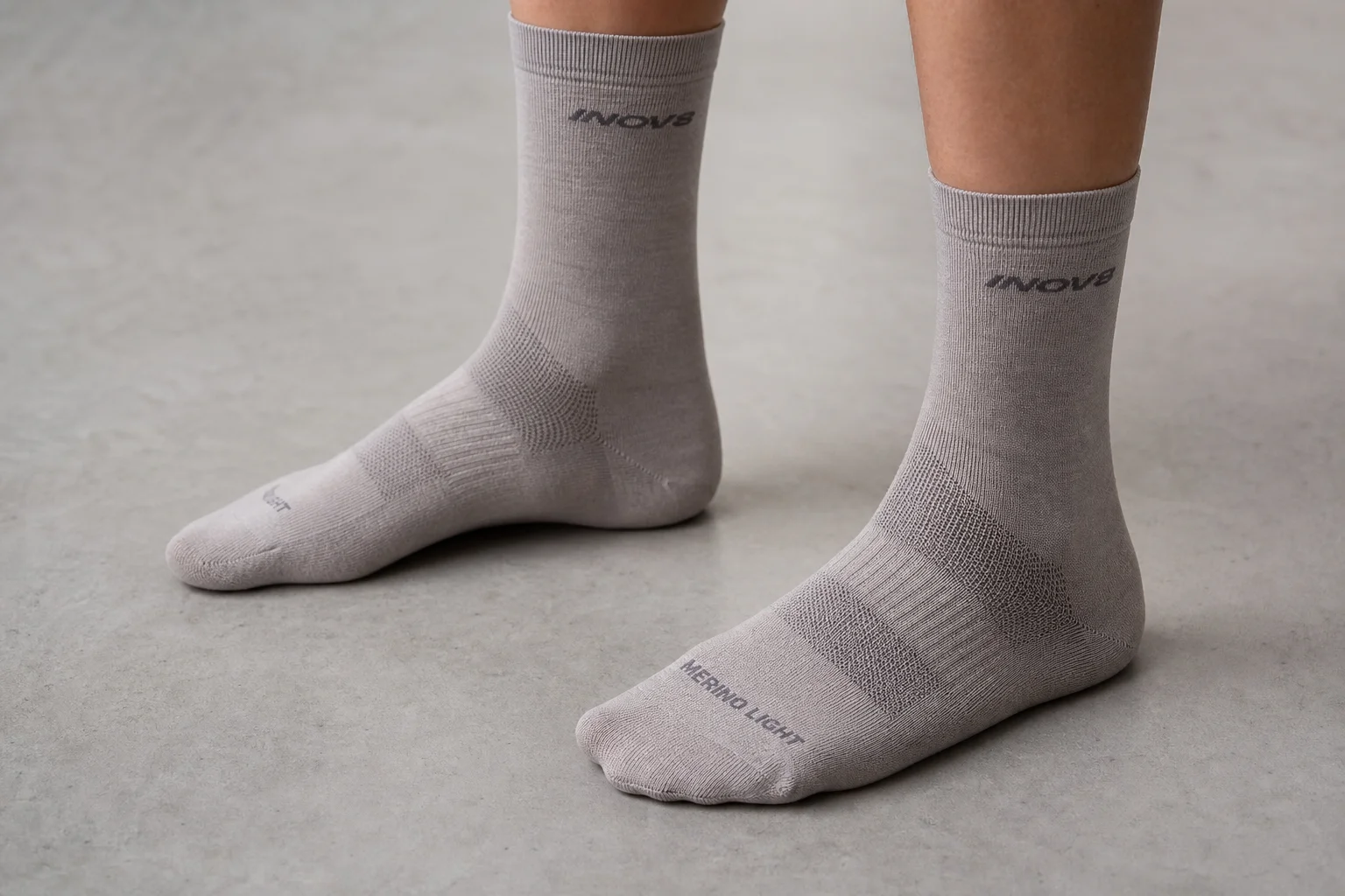 Collection of various running socks in different colors and styles on neutral backdrop