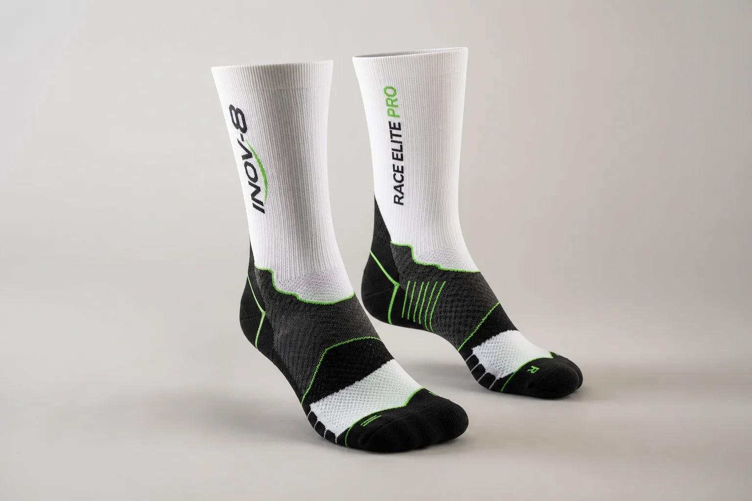 Collection of various running socks in different colors and styles on neutral backdrop