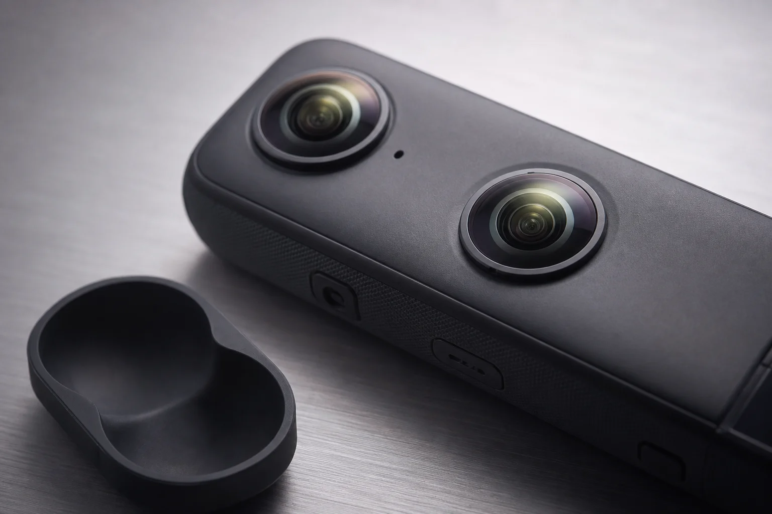Close-up of Insta360 X3 dual-lens array and protective lens cap