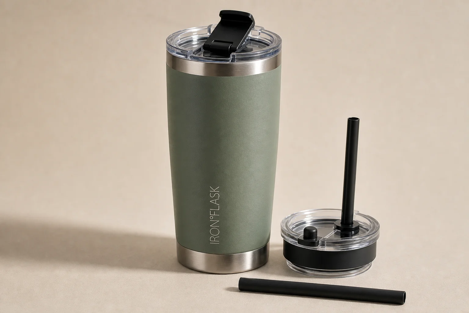 Five travel mugs arranged in ranking order on a concrete surface