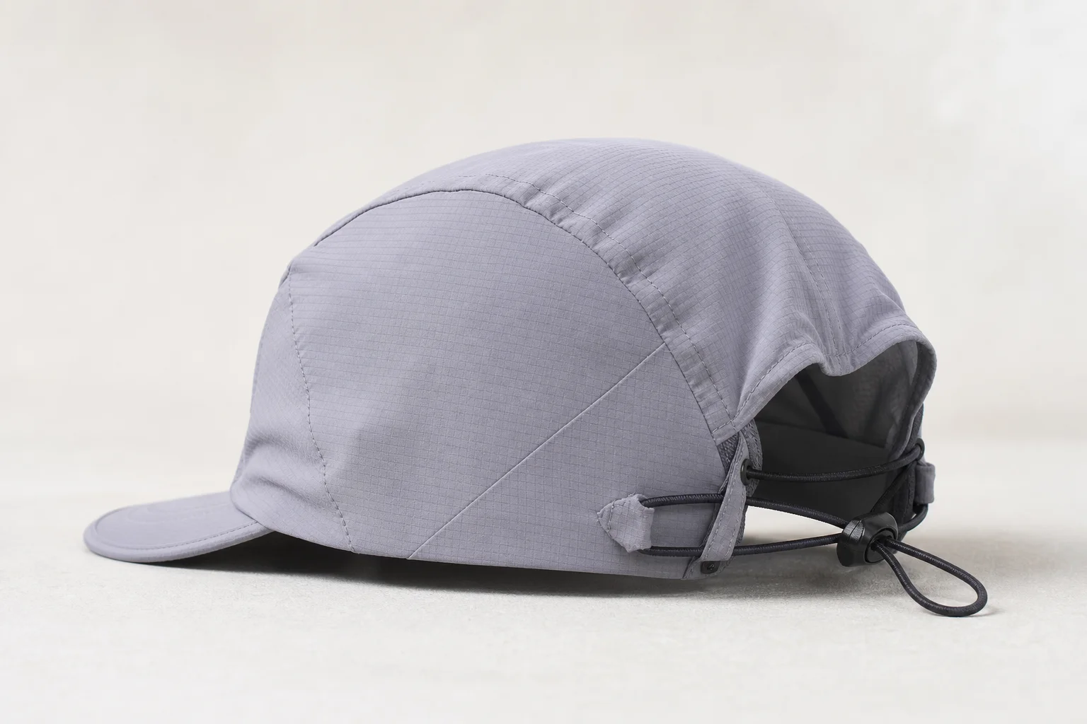 Nine running caps in various styles and colors arranged on neutral backdrop