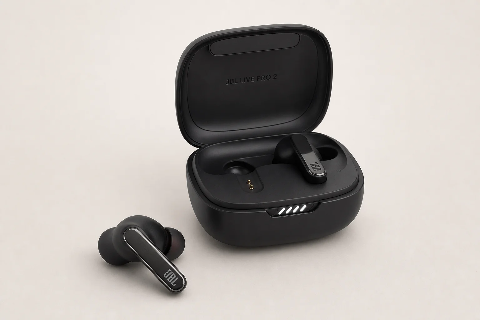 Five JBL earbud models arranged on concrete surface