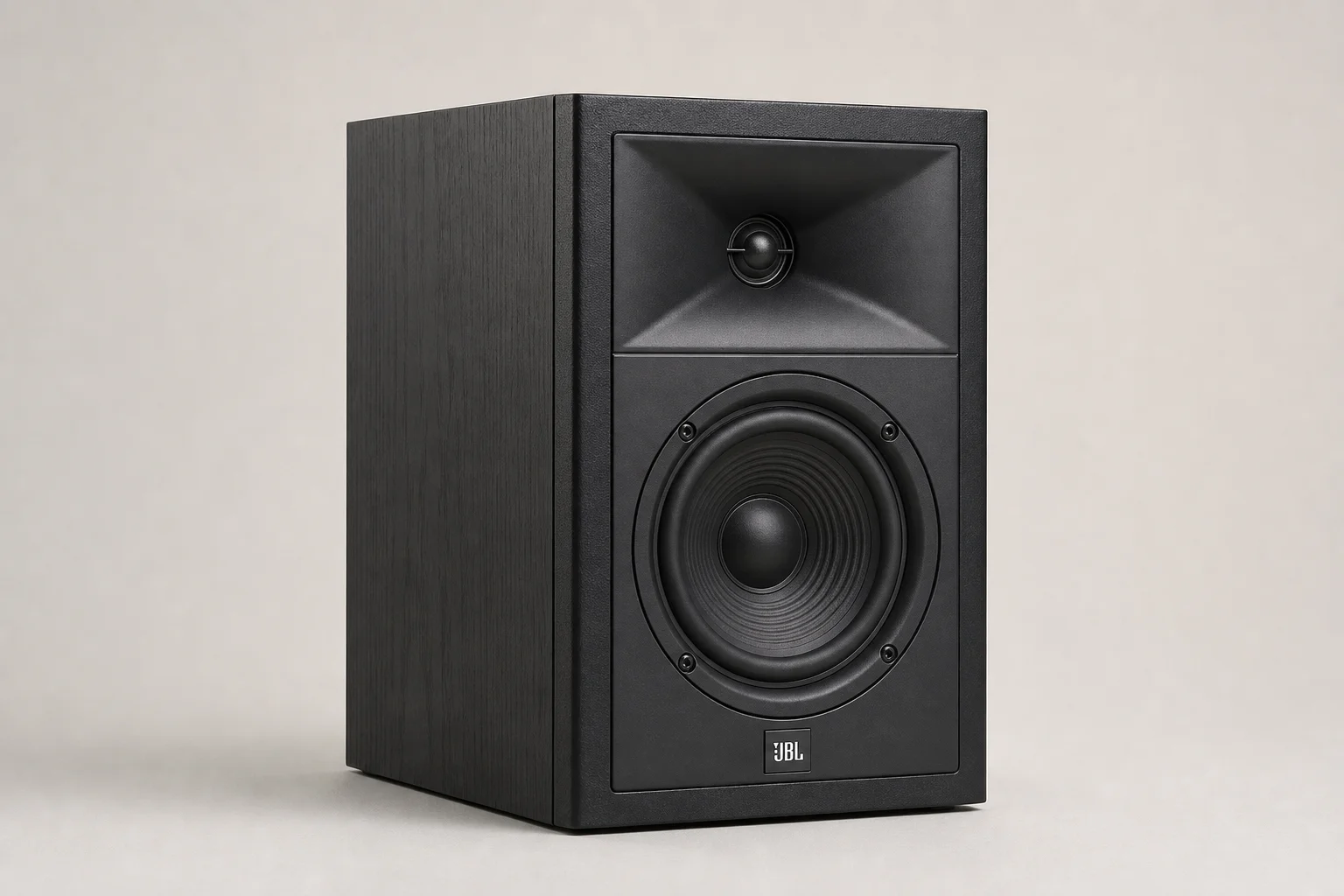 Six bookshelf speakers in varying sizes and finishes arranged on concrete surface