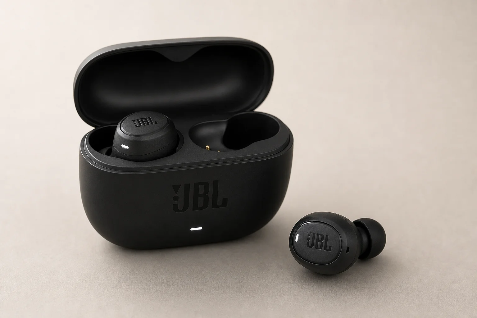 Five JBL earbud models arranged on concrete surface