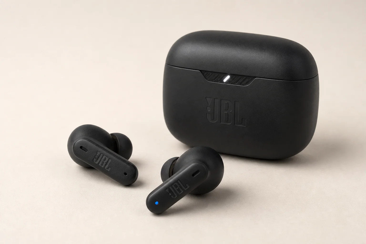 Five JBL earbud models arranged on concrete surface