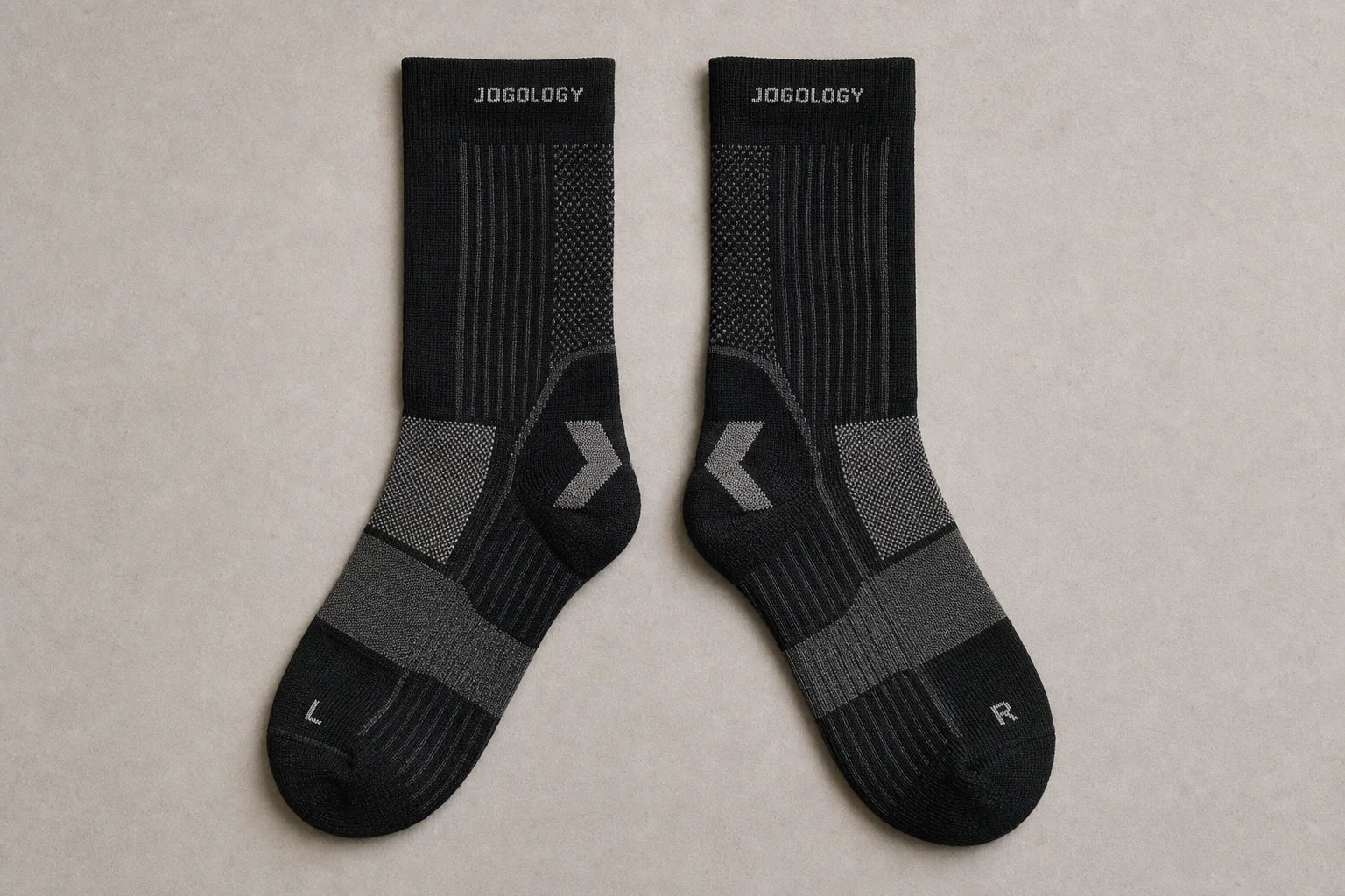 Collection of running socks in various colors and styles arranged on concrete surface
