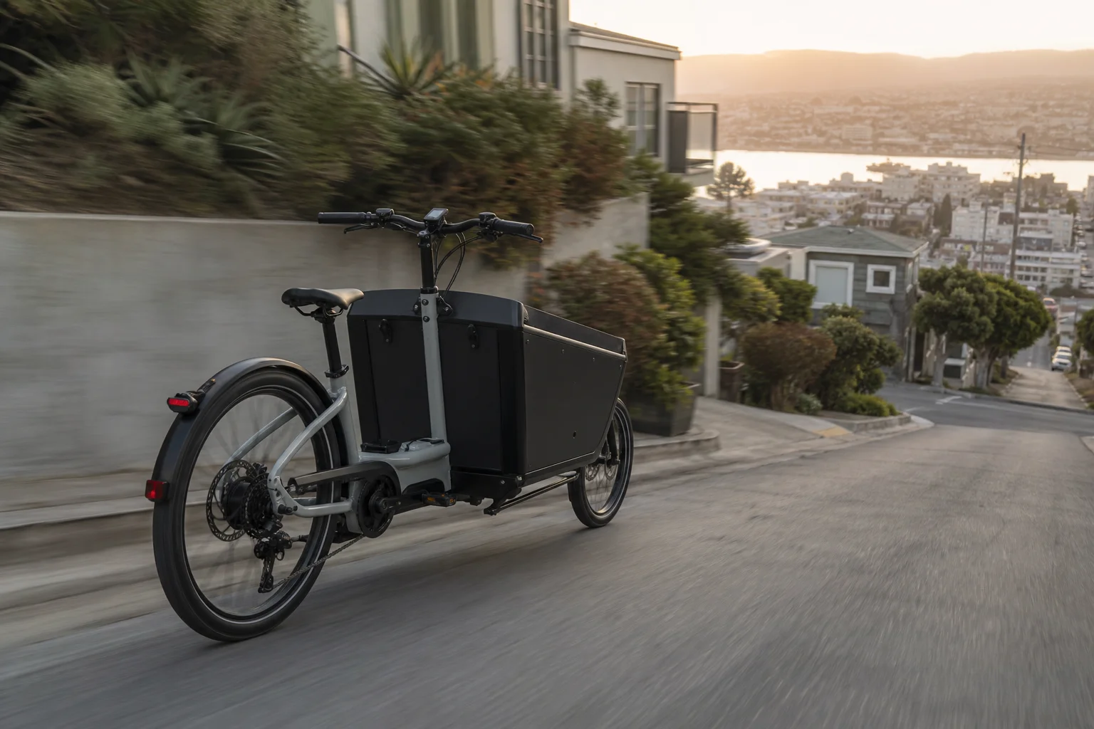 Cargo bike descending a steep hill with brake dust visible
