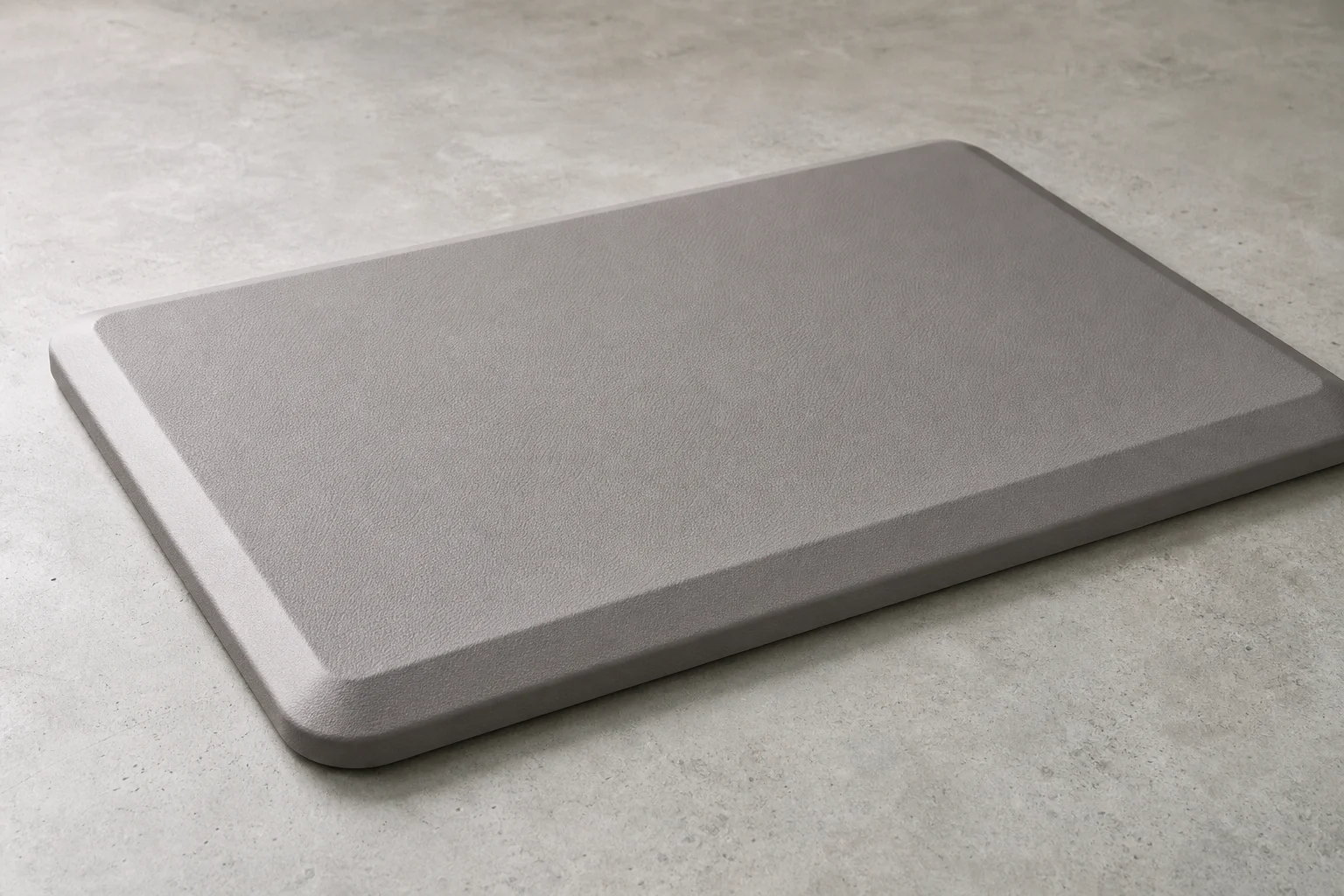 Five anti-fatigue mats and balance boards arranged on grey backdrop