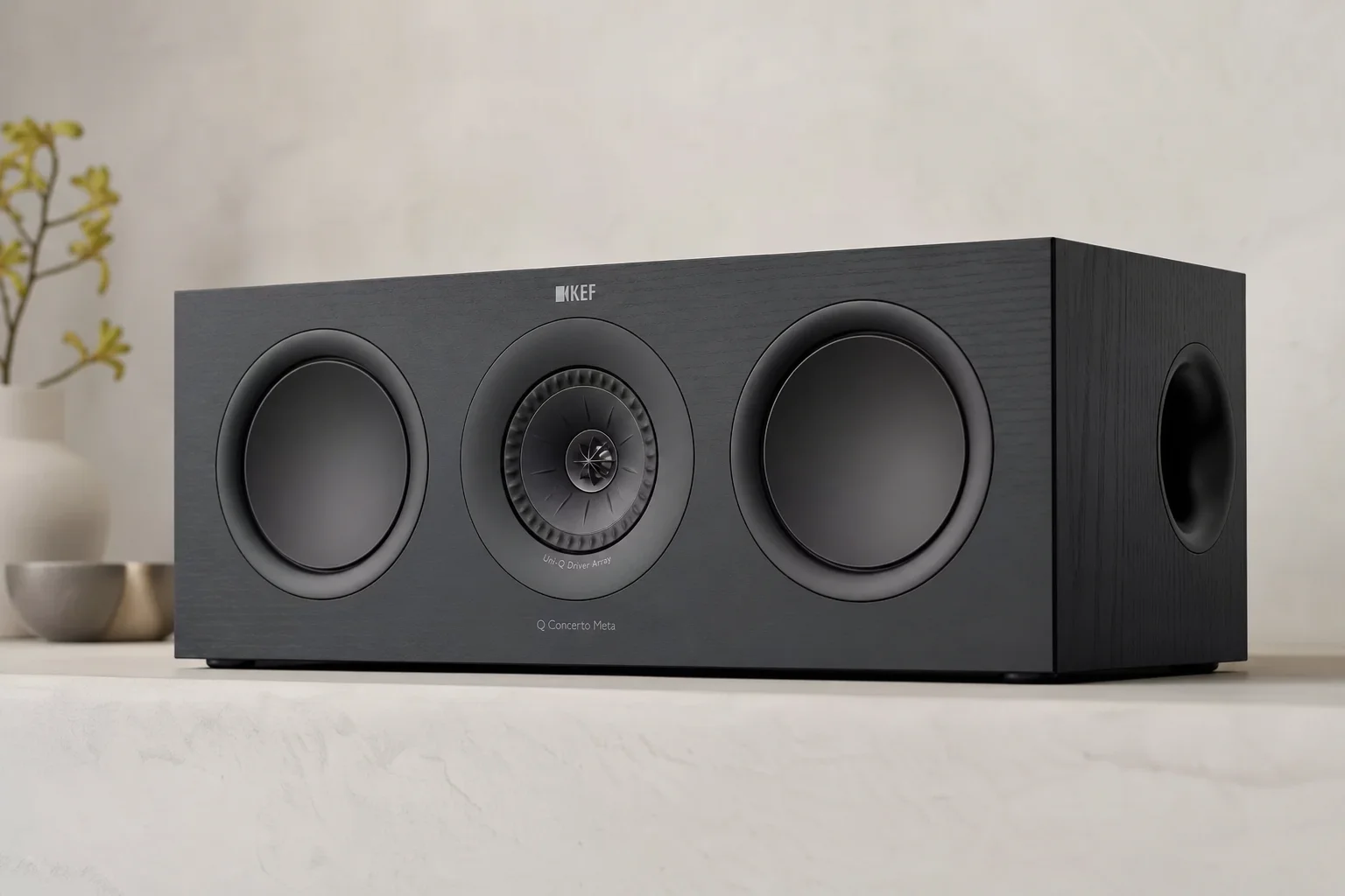 Six bookshelf speakers in various finishes arranged on concrete surface