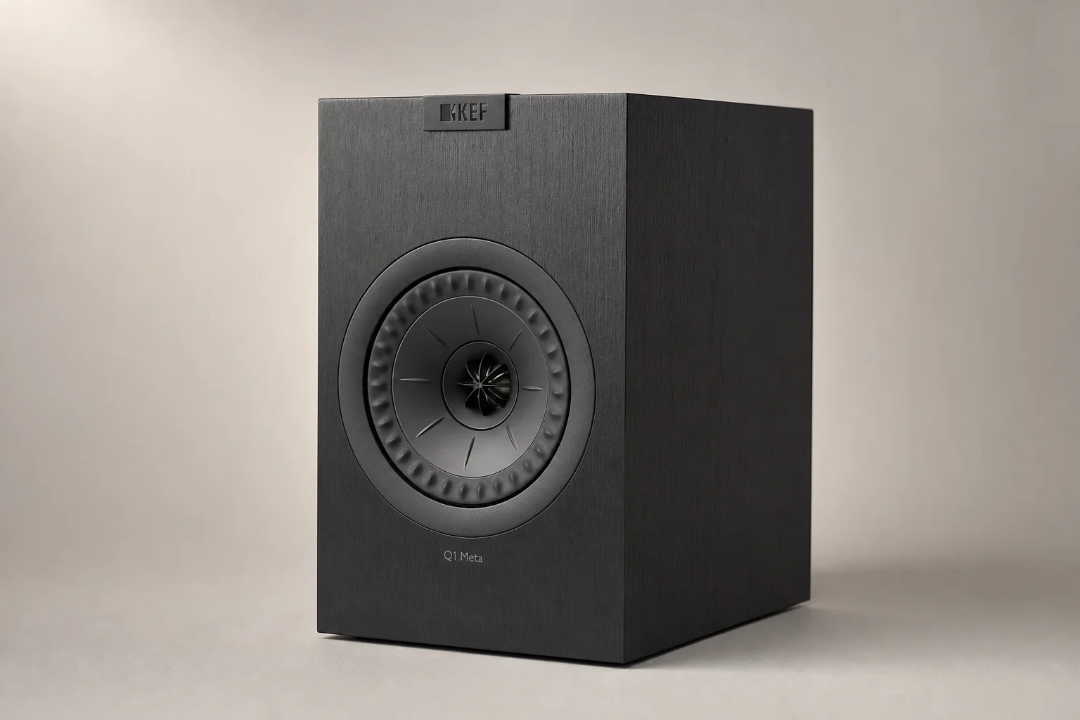 Six bookshelf speakers in varying sizes and finishes arranged on concrete surface