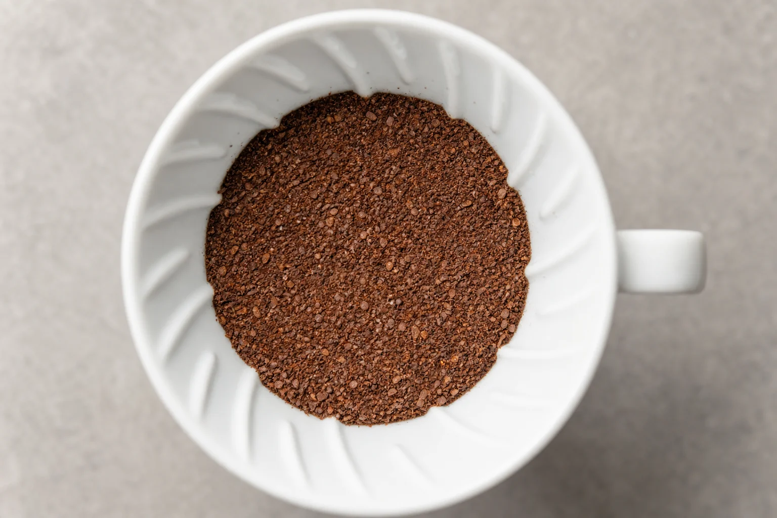 Coffee grounds in a V60 dripper showing particle distribution