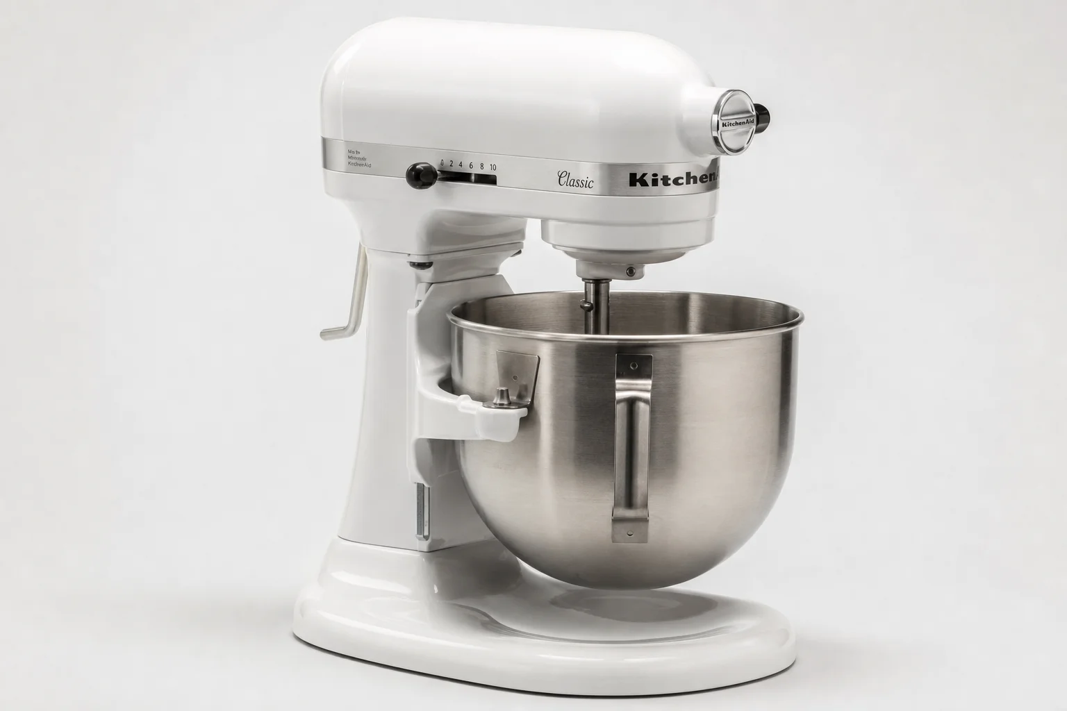 Four stand mixers in different sizes and styles arranged on a neutral backdrop