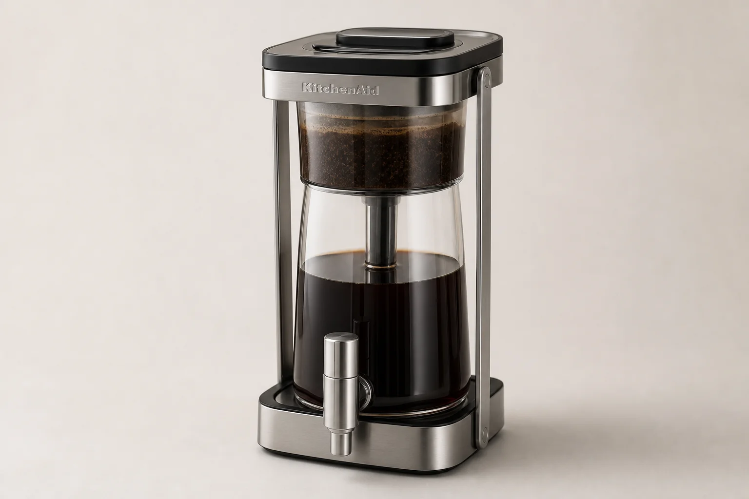 Four cold brew coffee makers displayed on concrete surface