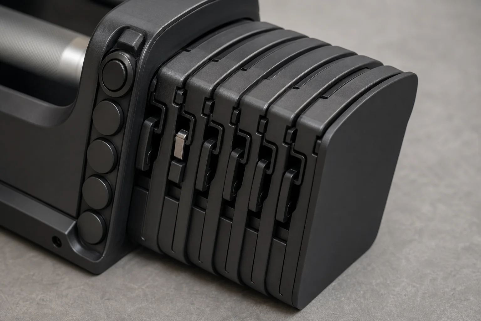 Close-up of weight adjustment buttons and connector mechanism on the dumbbell