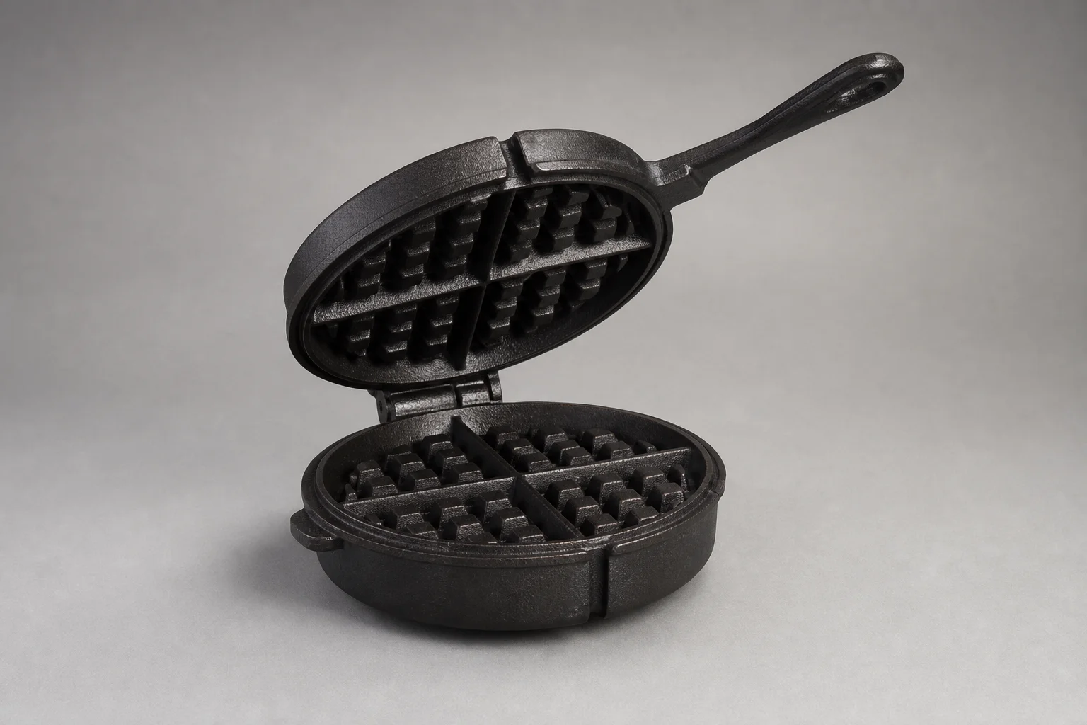 Five non-toxic waffle makers arranged on concrete surface