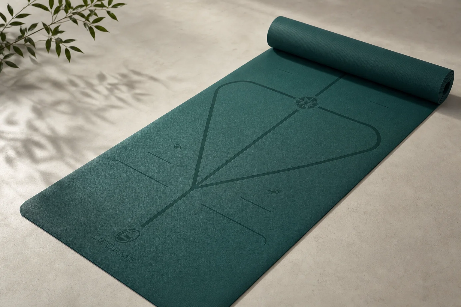Seven different yoga mats arranged on a wooden floor showing variety of styles and colors
