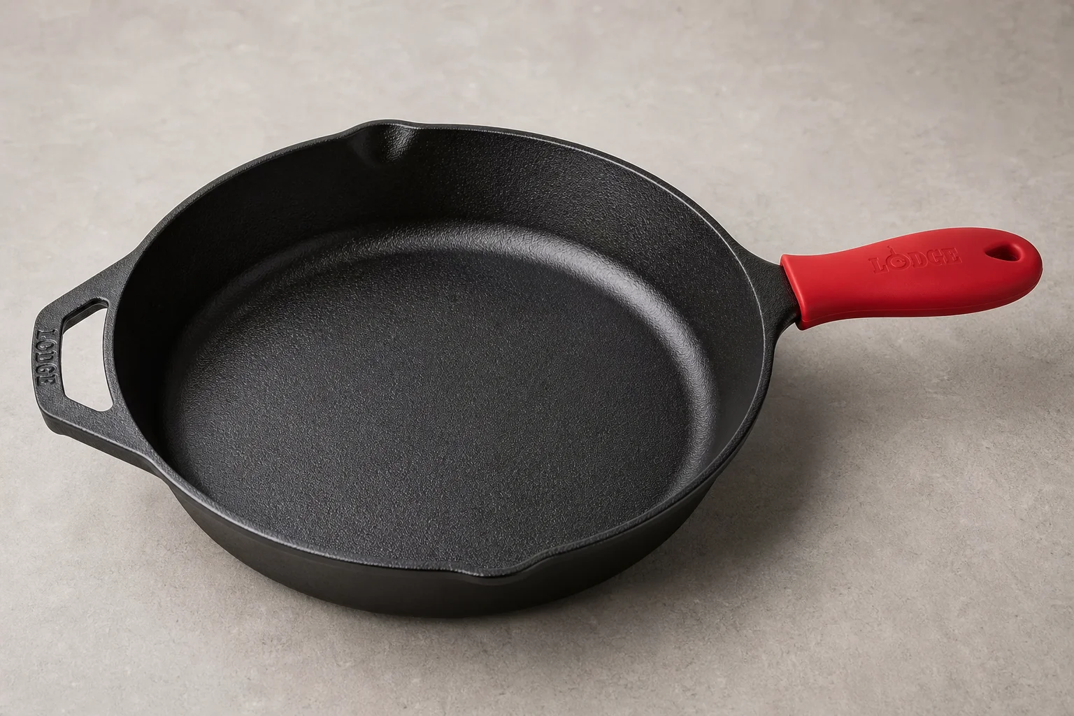 Five cast iron skillets arranged on a wooden surface showing different styles and finishes