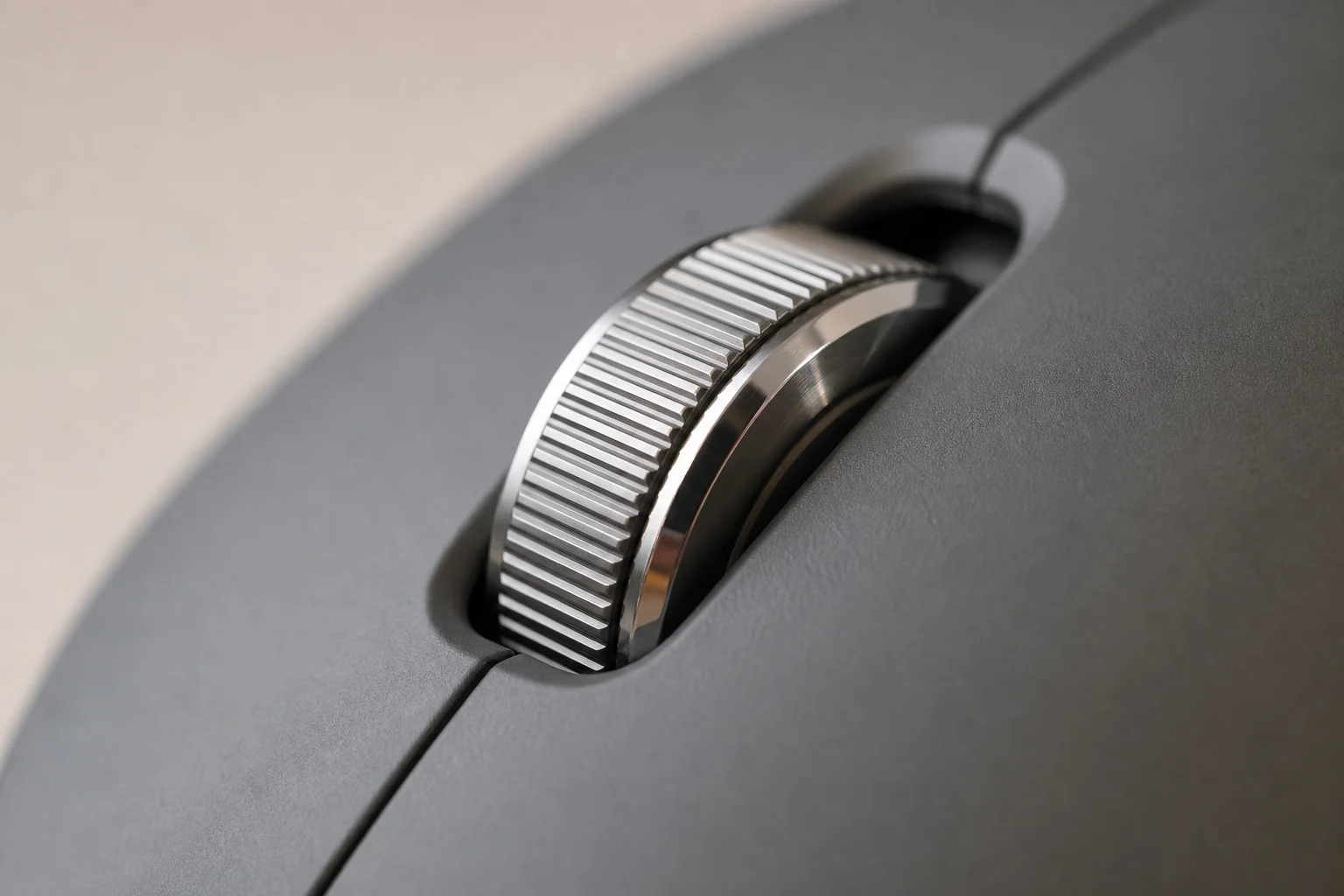 Steel scroll wheel detail on ergonomic mouse with tactile ridges