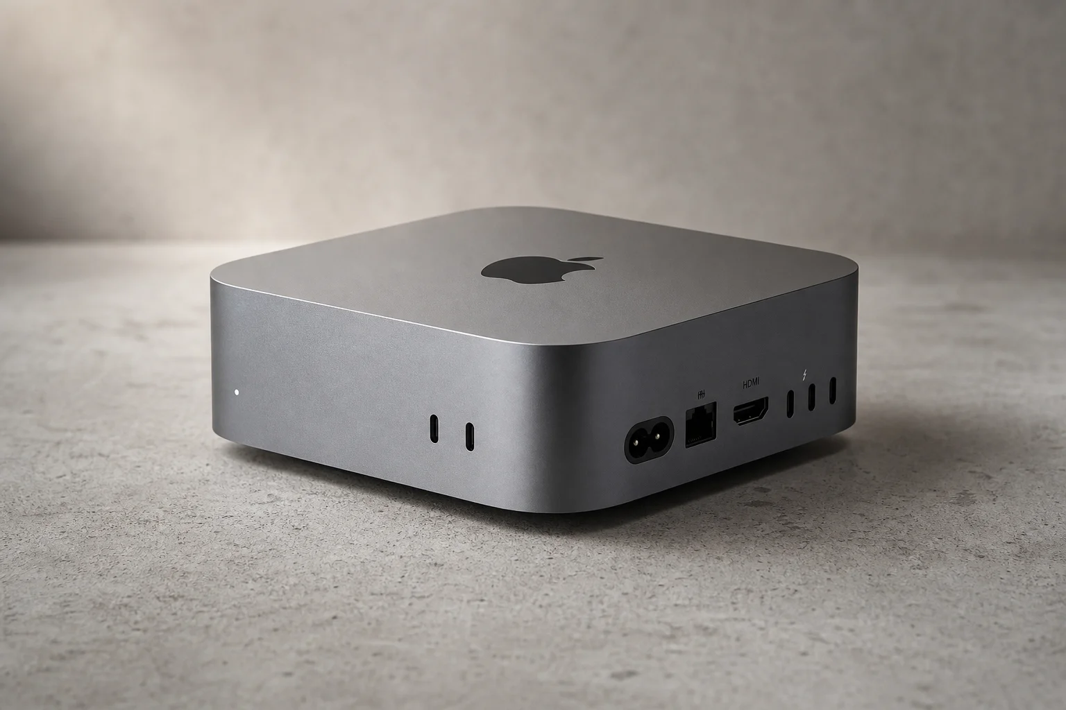 Mac mini M4 compact desktop computer on neutral surface showing ports and form factor