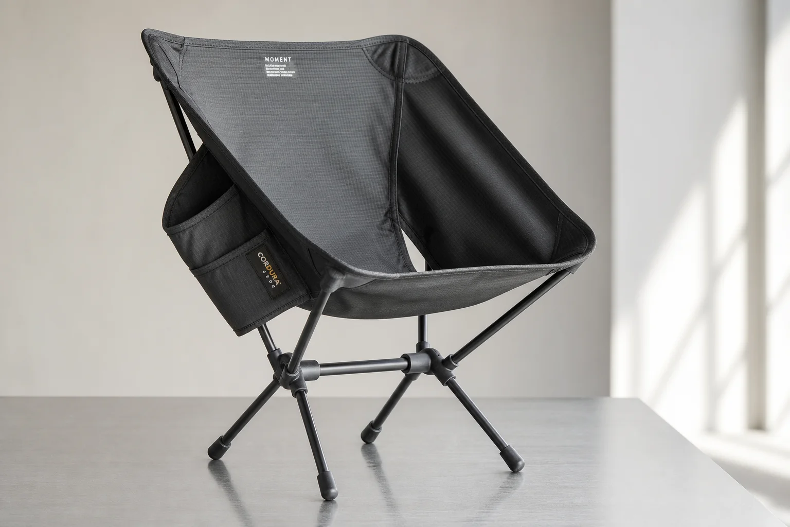 Four ultralight camping chairs arranged on neutral backdrop