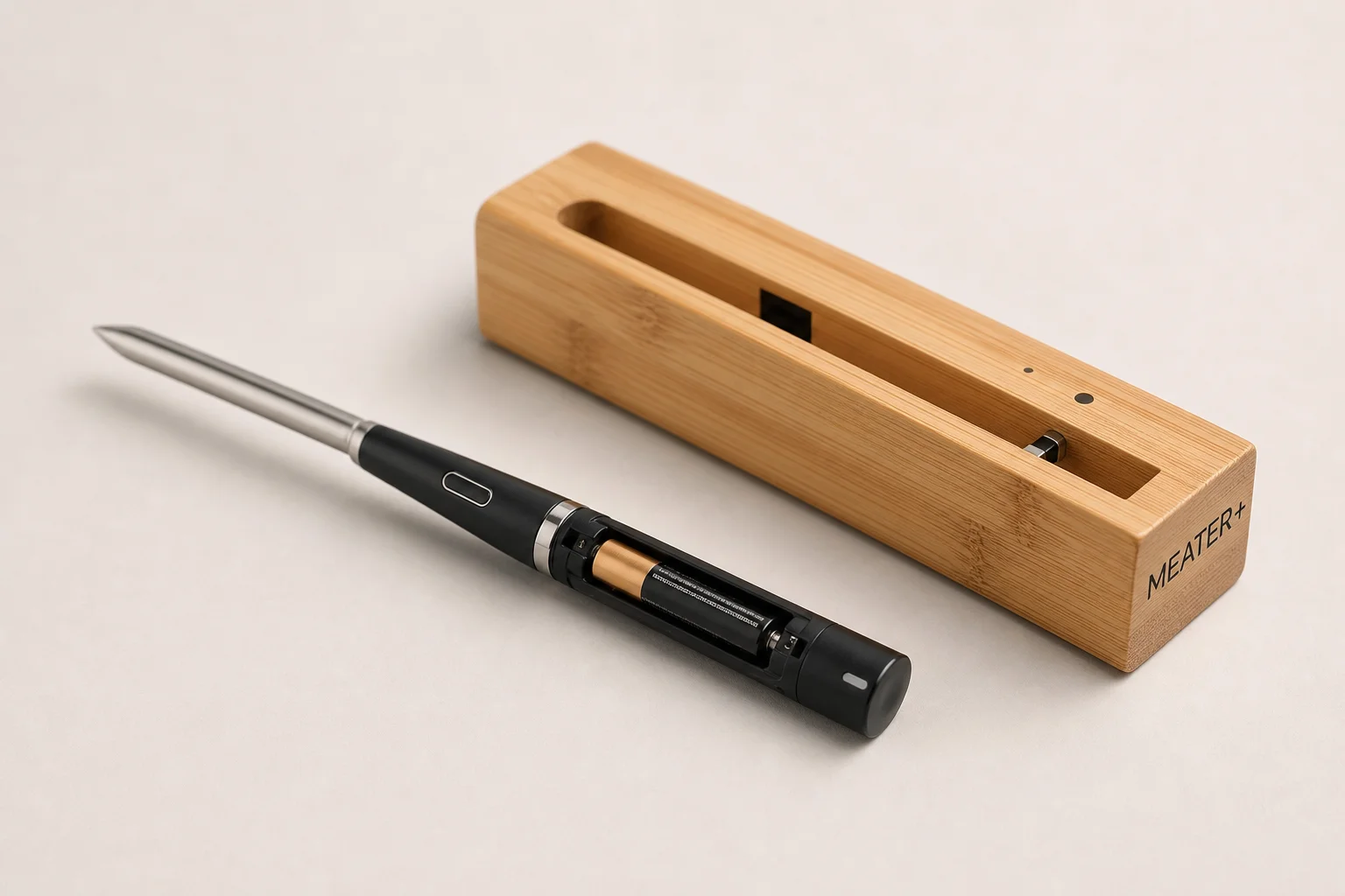 Three smart meat thermometer systems displayed on concrete surface