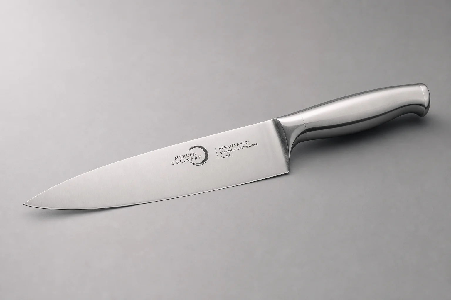 Two 8-inch chef's knives on a wooden cutting board