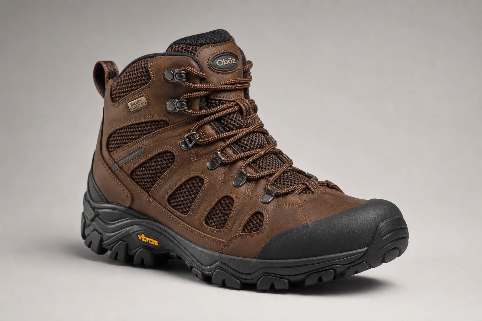 Five hiking boots arranged diagonally on concrete surface