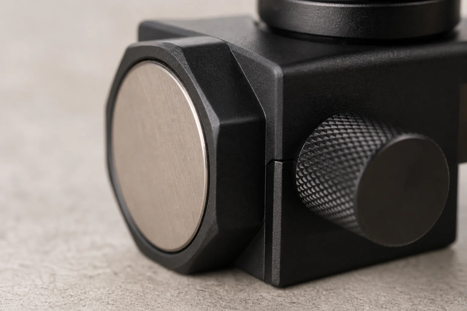 Close-up of laser base showing magnetic mounting surface and adjustment knob