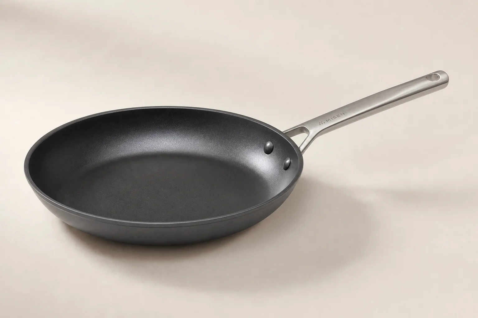 Five cookware brands displayed together on neutral backdrop