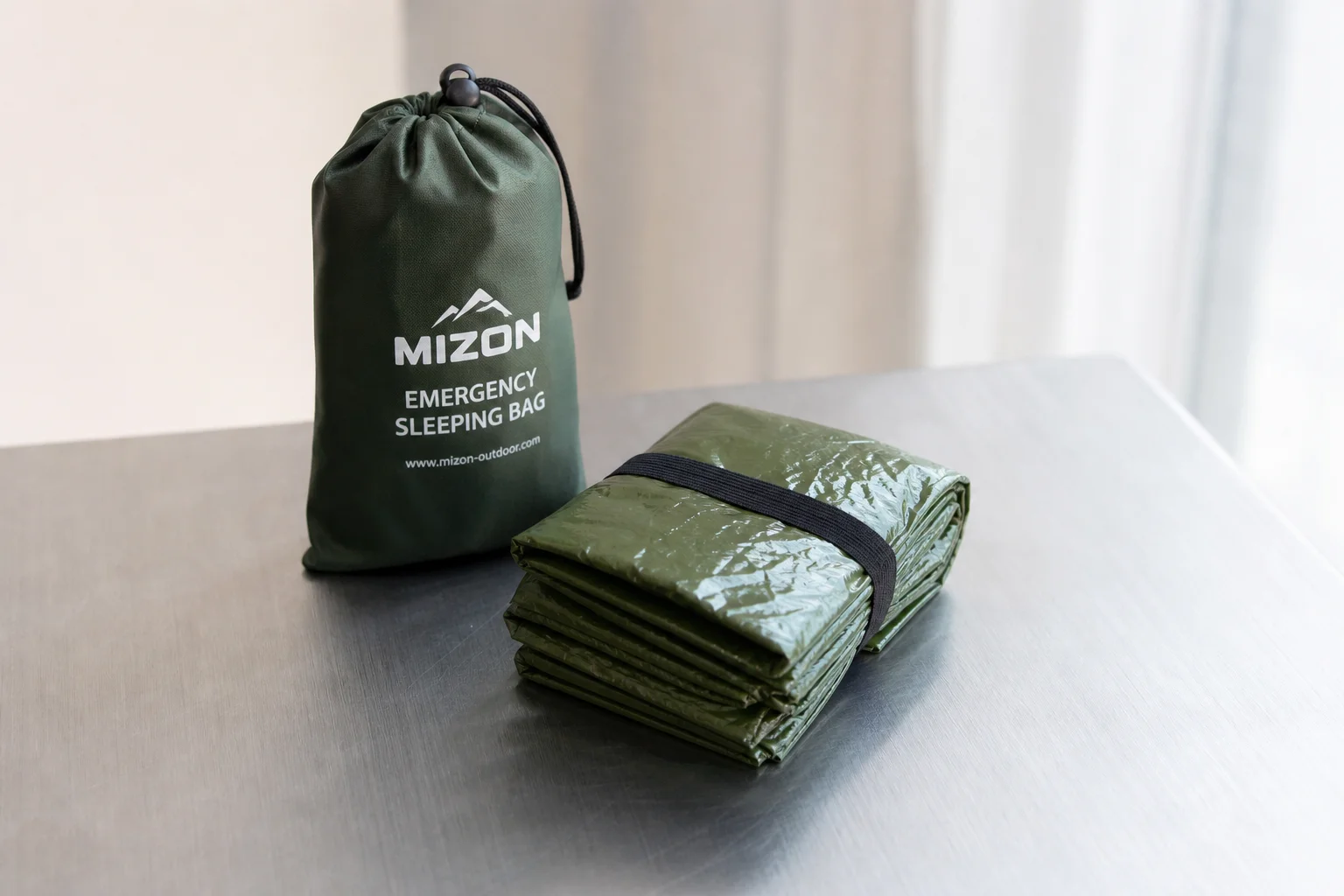 Five survival bivvy sacks in various colors arranged on concrete surface