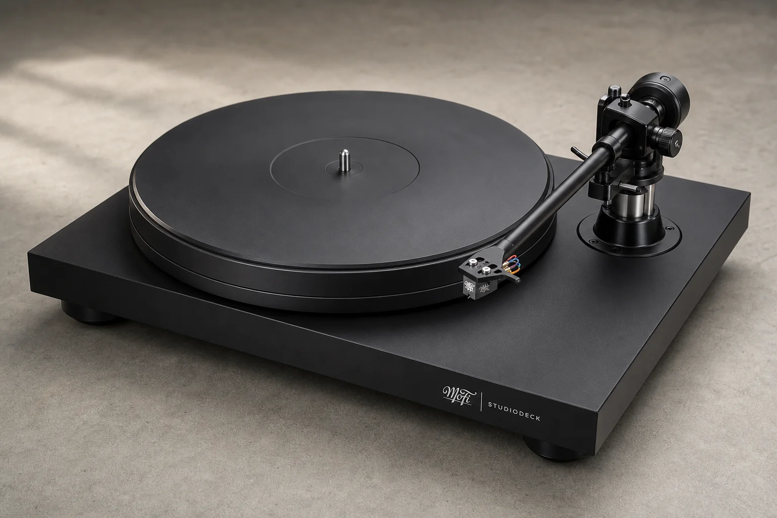 Six turntables displayed on concrete surface showing variety of designs and finishes
