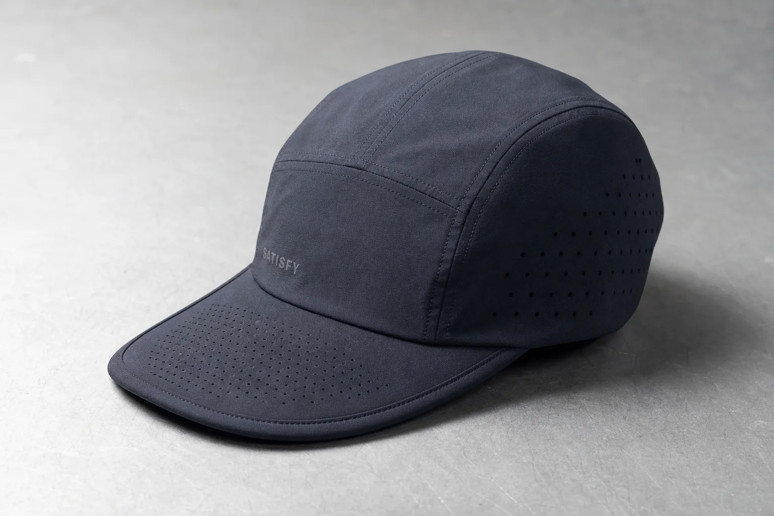 Collection of nine running caps in various styles and colors on neutral background