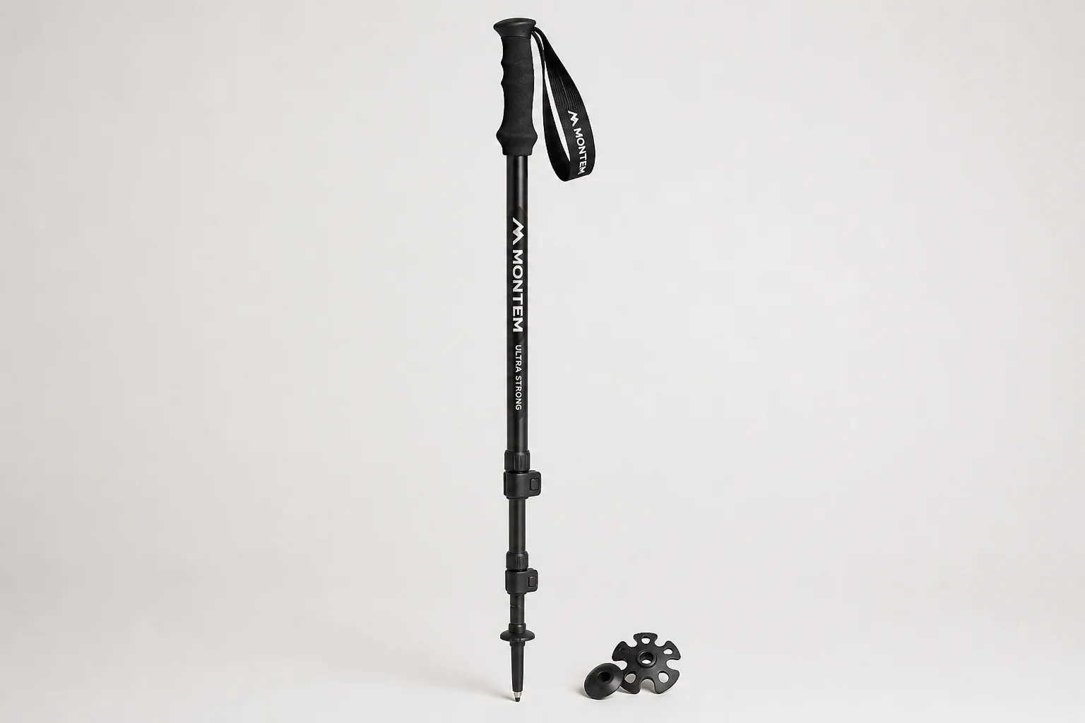 Five hiking poles arranged in a fan pattern on concrete surface