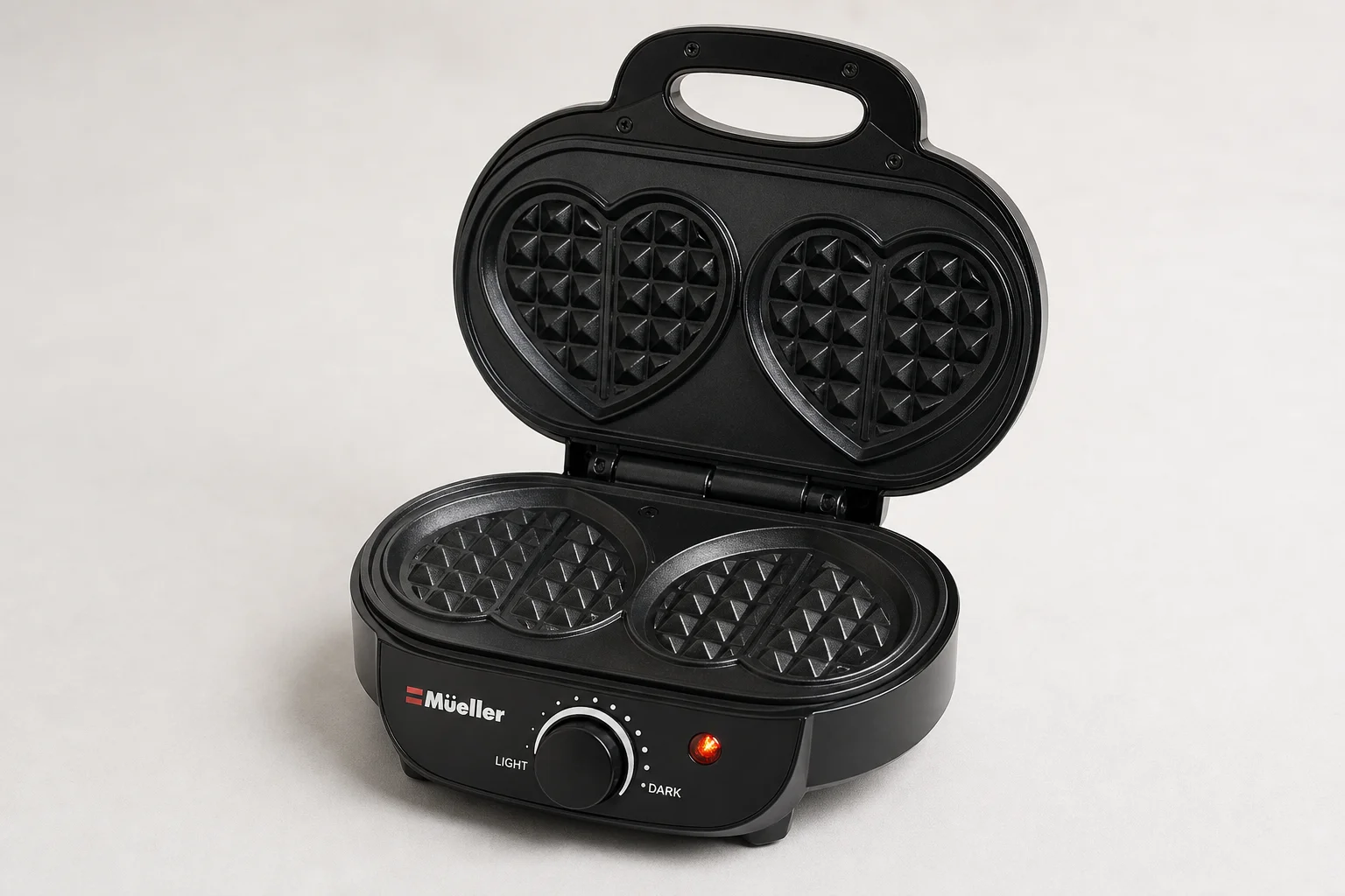 Five waffle makers arranged on concrete surface from budget to premium models