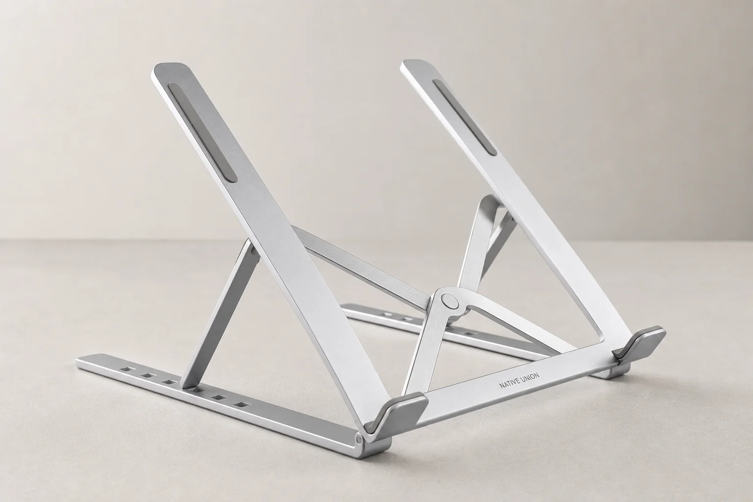Complete modern desk setup with walnut desk, monitor, chair, speakers, and accessories
