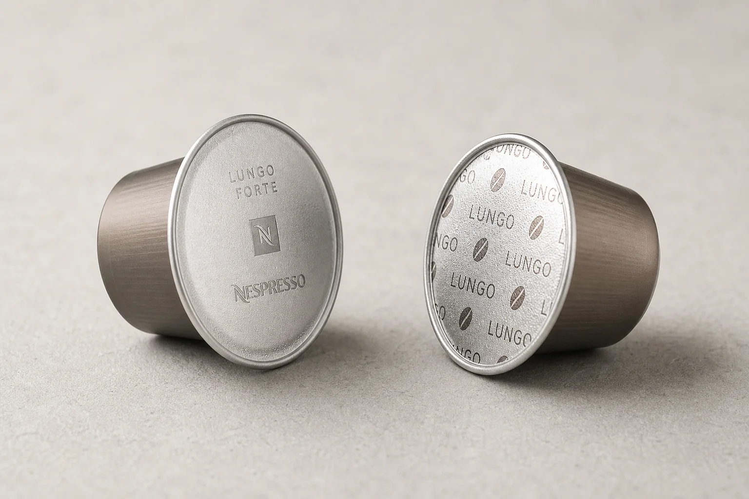 Nespresso and independent compatible capsules side by side on concrete