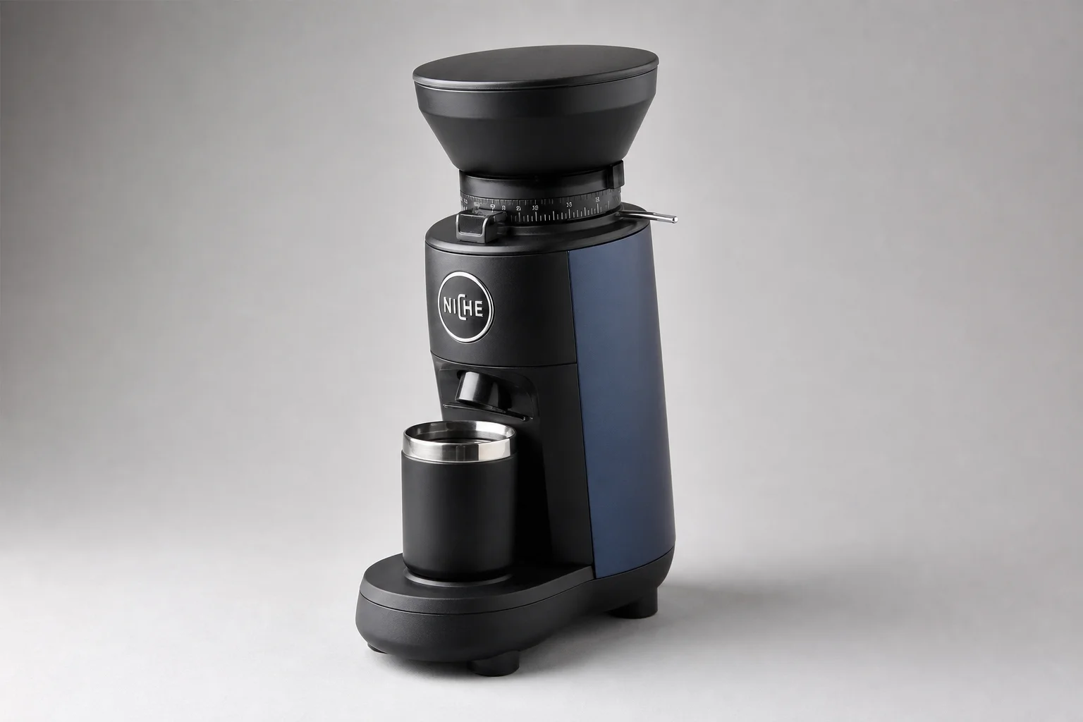 Niche Duo grinder with black and blue finish on neutral grey background