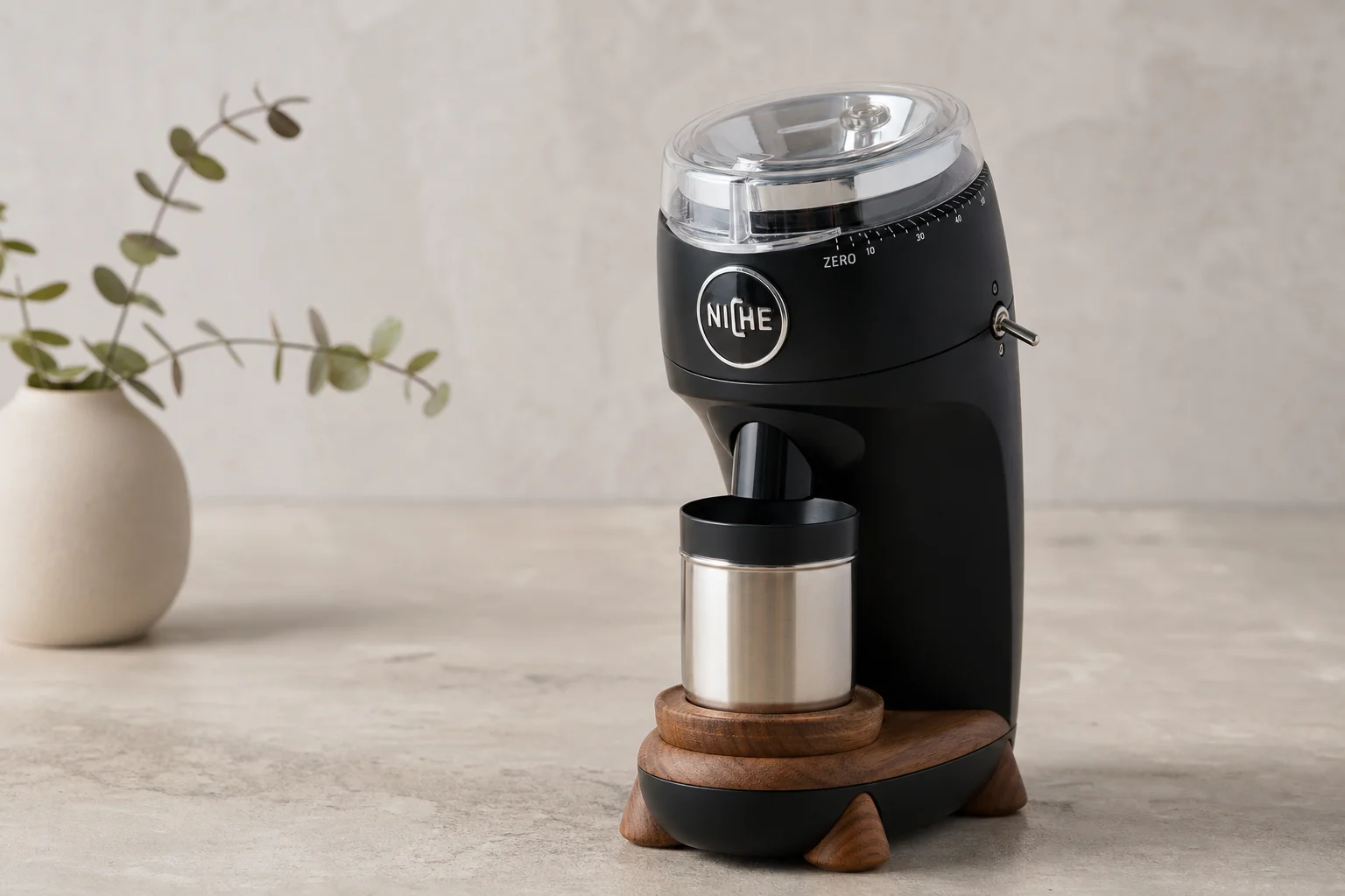 Niche Zero coffee grinder with wood accents and adjustable dial on neutral surface