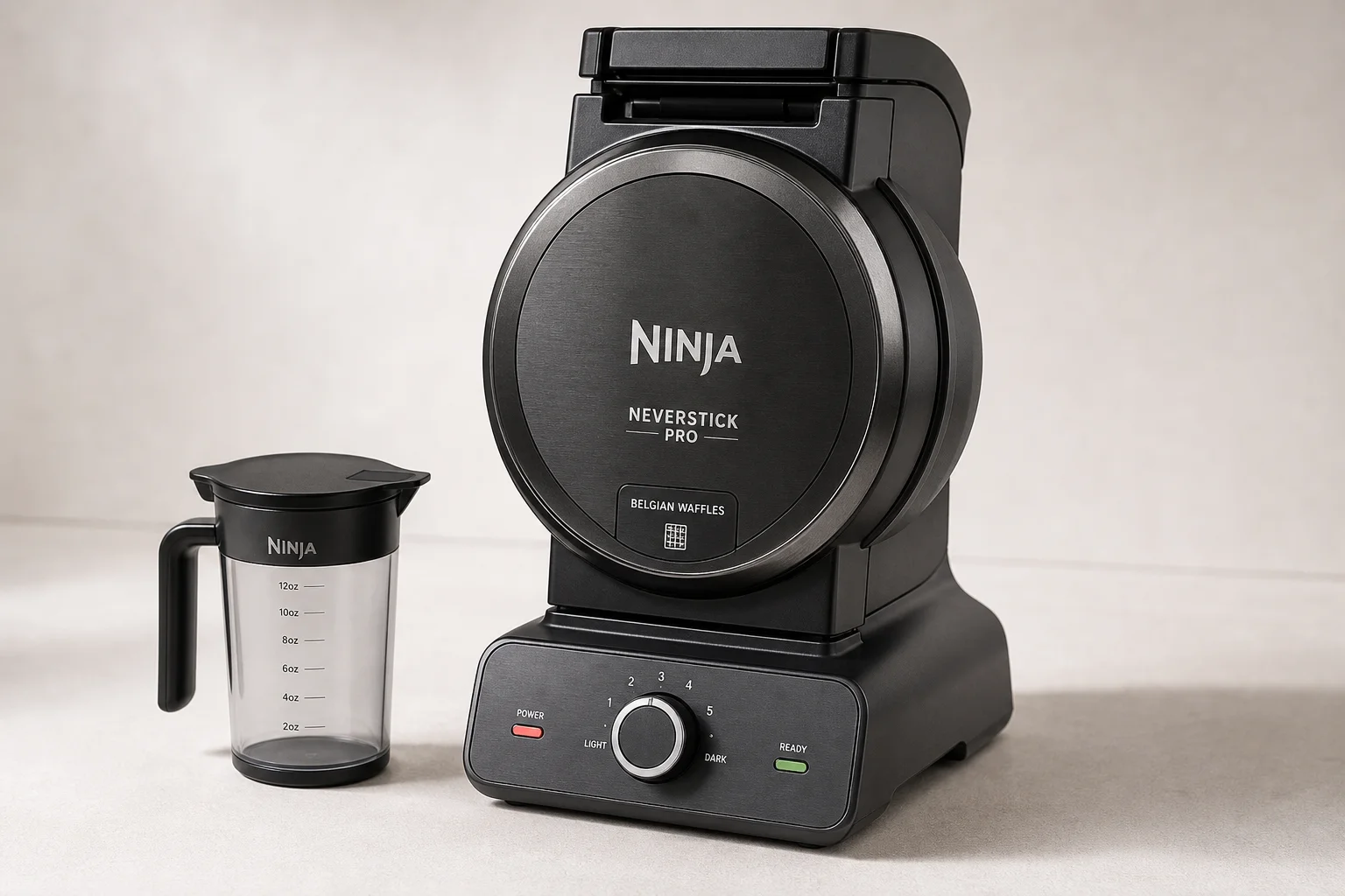 Five waffle makers arranged on concrete surface from budget to premium models