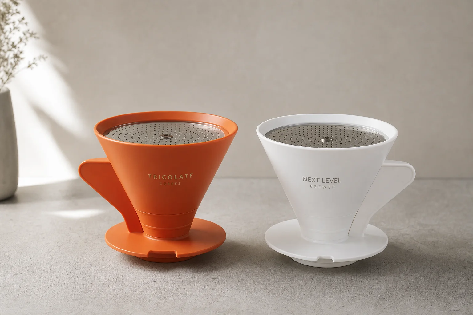 Tricolate and Next Level pour-over brewers side by side on concrete